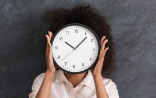 woman practicing time management holding a clock